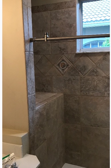 Master bath before remodel — dated tile and tub