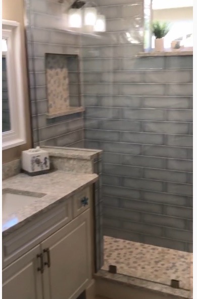Strong Tower master bath remodel, after — custom tile shower, stone vanity, recessed niche
